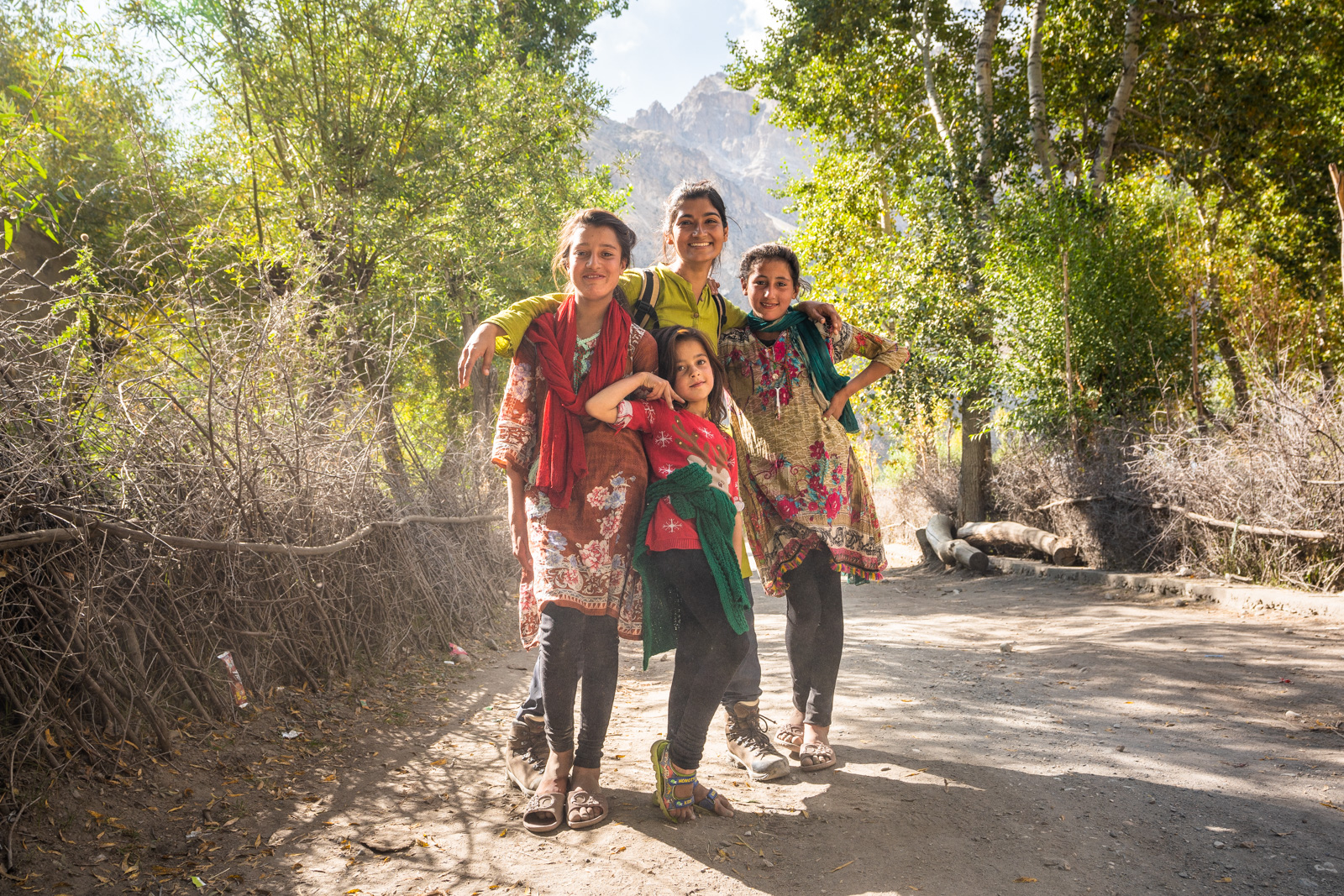 Female tourist with local kids in Ghizer - Gilgit Baltistan